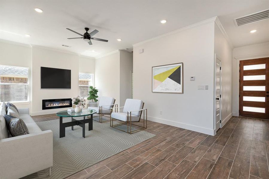 Living room with ornamental molding, ceiling fan, and dark hardwood / wood-style flooring