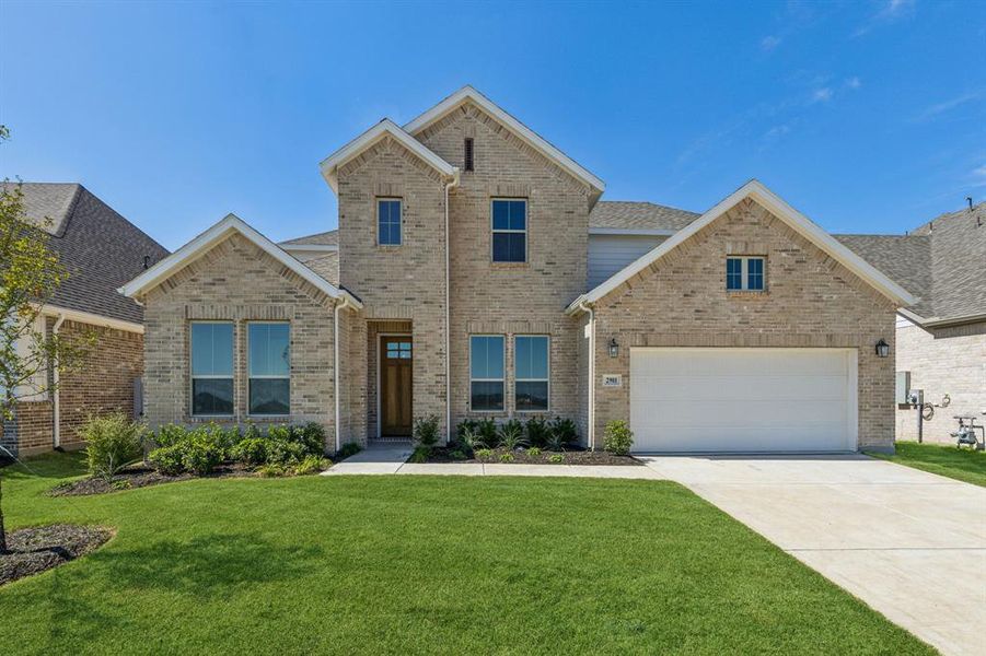 View of front of house with a garage and a front lawn