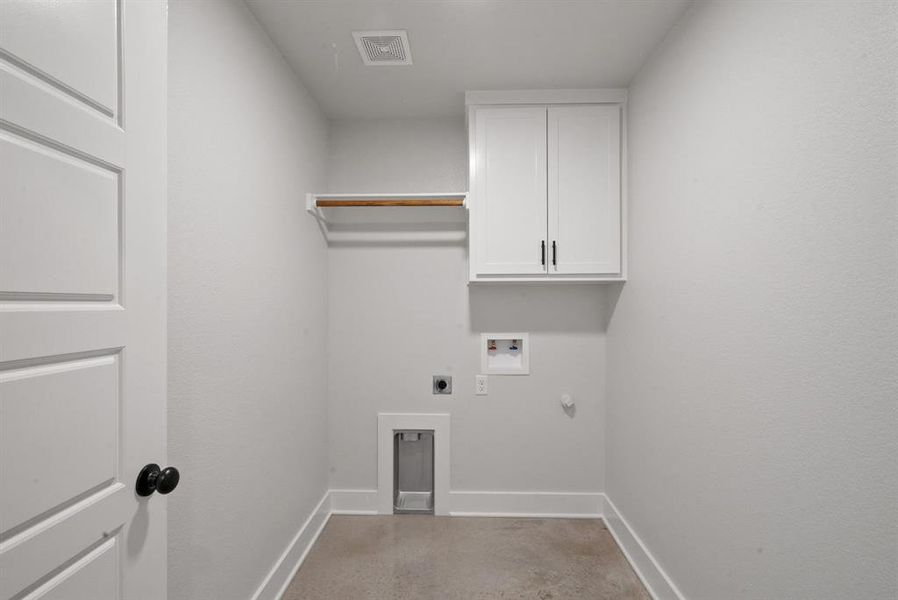 Washroom featuring hookup for an electric dryer, washer hookup, cabinets, and hookup for a gas dryer