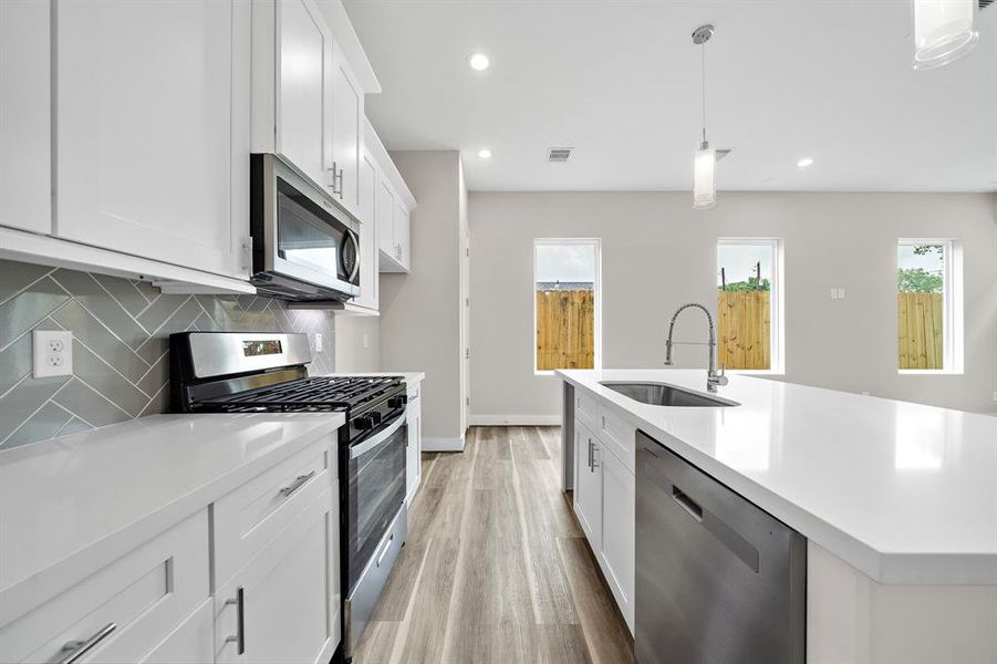 Kitchen also offers natural lighting from windows surrounding area, appliances, recessed lighting and access to the Dining Area for meals together.