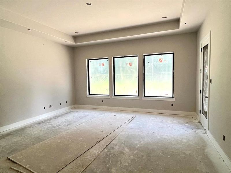 Gameroom with coffered ceiling and access to the covered patio