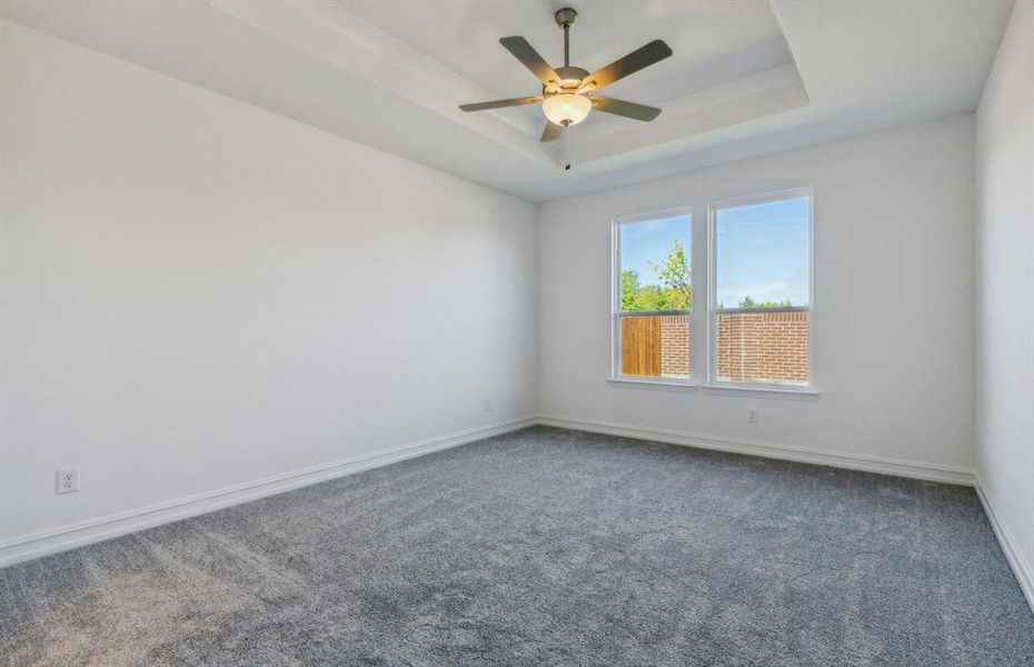 Elegant owner's suite with Tray ceiling *real home pictured