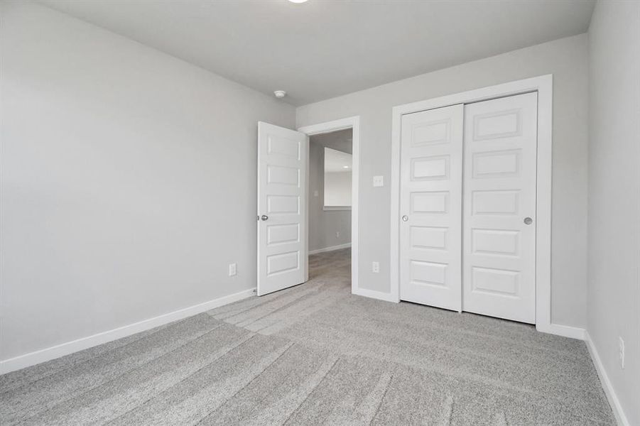 Generously sized secondary bedrooms featuring spacious closets, soft and inviting carpeting underfoot, large windows allowing plenty of natural light