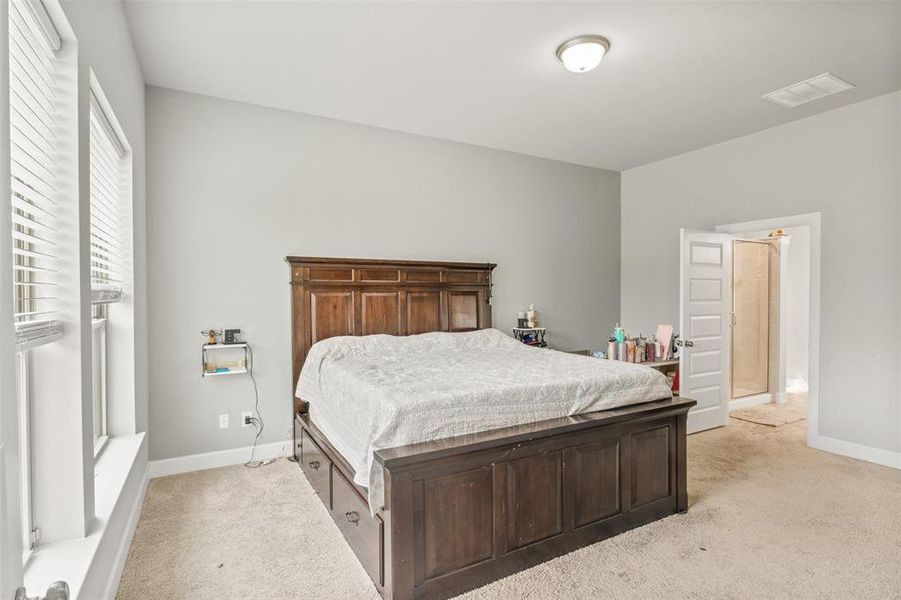 Bedroom featuring light colored carpet