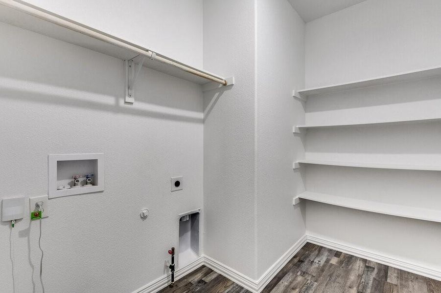 Washroom featuring hookup for a gas dryer, hookup for an electric dryer, hookup for a washing machine, and dark hardwood / wood-style floors