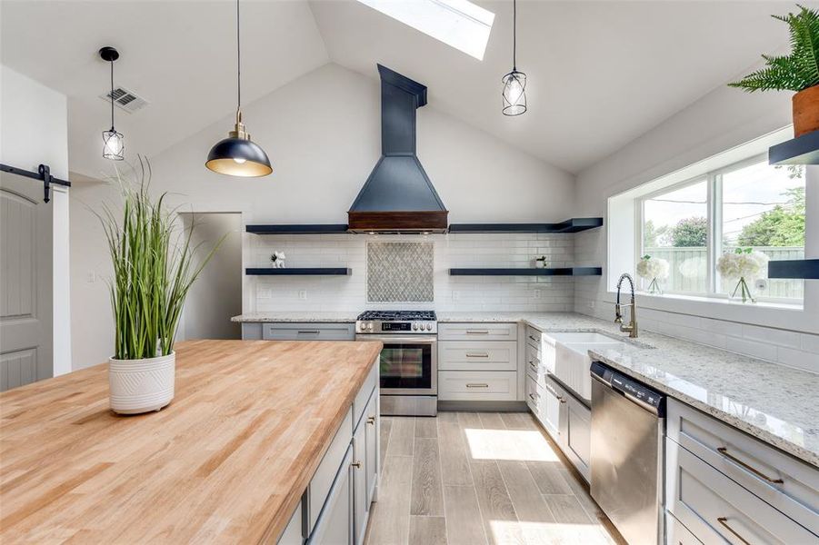 Massive butcher block island, 3 skylights pouring in light, floating shelves custom oversized and extremely deep countertop plus a commercial grade hood all welcome you into your new home.