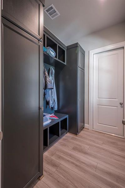 The mud room has custom cabinetry with soft close hardware on cabinet doors, cubbies for storage, hooks for jackets and a seat! This is a really cool well thought out feature! The mud room measures 11x6.