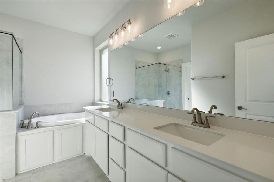 Bathroom with vanity, separate shower and tub, and tile patterned flooring