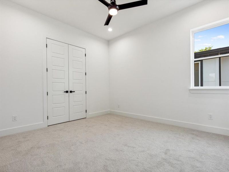 Unfurnished room with carpet floors and ceiling fan