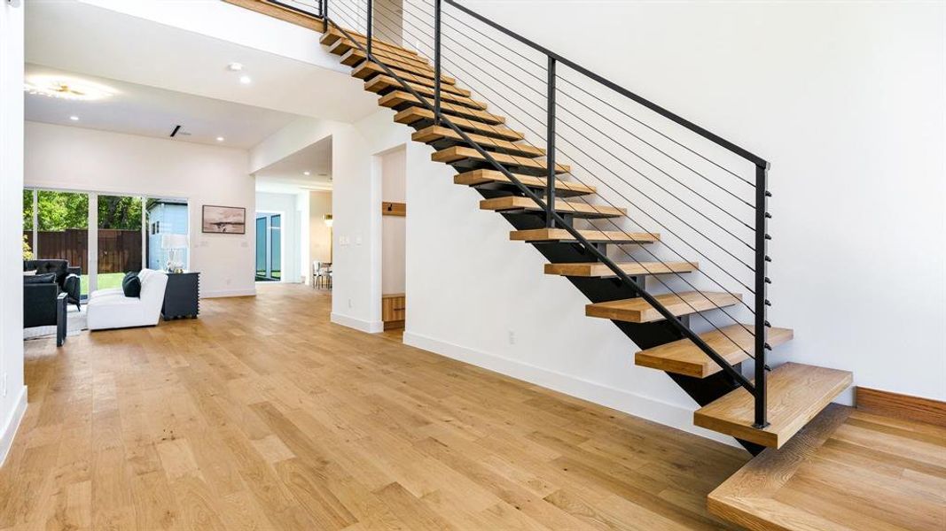 Stairs featuring hardwood / wood-style flooring