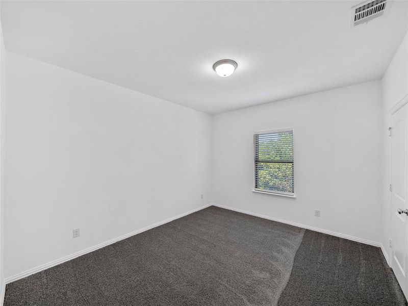 Unfurnished room with dark carpet