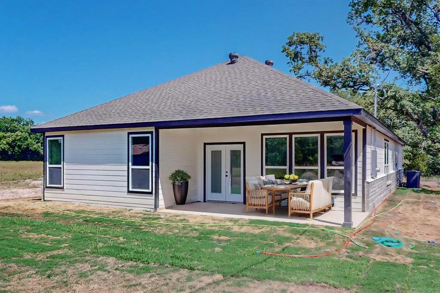 Staged Rear view of house featuring a patio and a yard