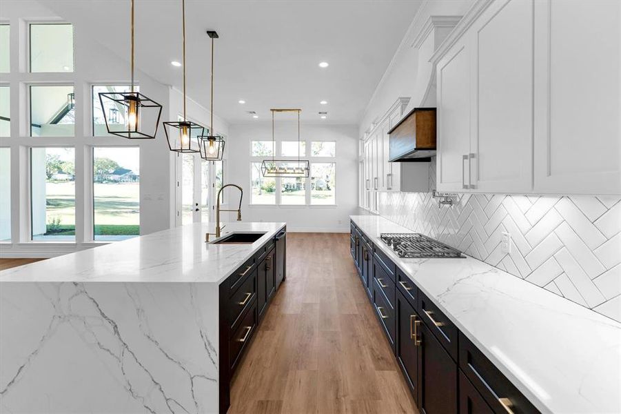 Convenient under cabinet accent lighting throughout and tons of storage keeps things clean and organized in this dream kitchen!