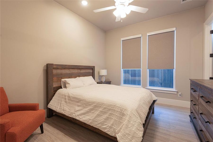 Secondary Bedroom featuring ceiling fan and light tones.