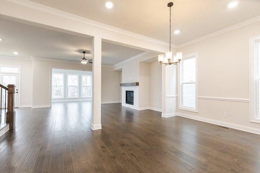 The open concept design of the main level creates a seamless flow between the kitchen, dining area, and family room, perfect for everyday living.   Photo not actual home, but previously built Mansfield plan.