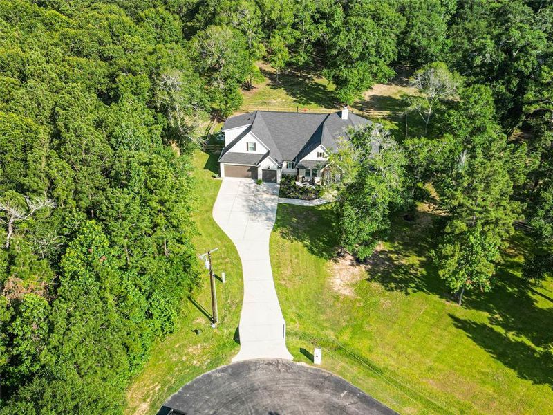 Perfectly situated at the end of a private cul-de-sac, this fabulous custom home offers a private driveway, 3-car attached garage, and 2.3 acres of heavily wooded land with a sprinkler system for easy care.