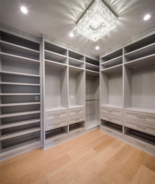 Gentlemen's dressing room with custom built-ins and crystal chandelier