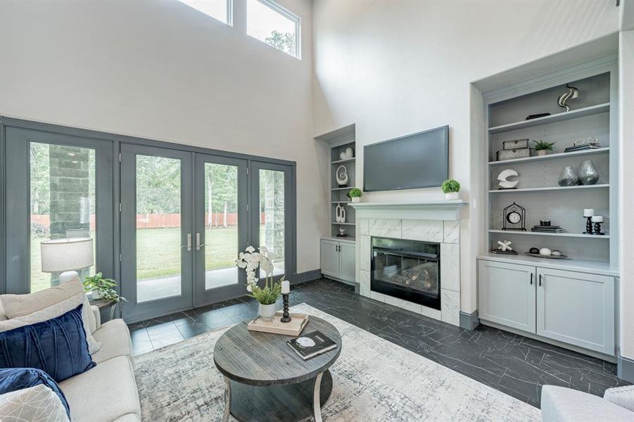 Picturesque living room with dramatic high ceilings and French doors