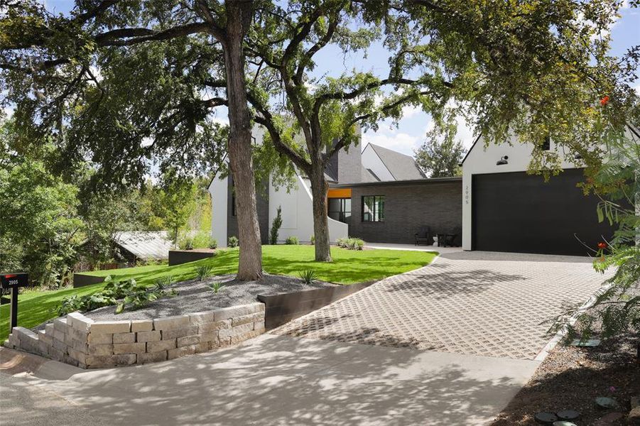 Added detail in the lattice style driveway tat leads to the custom garage doors.