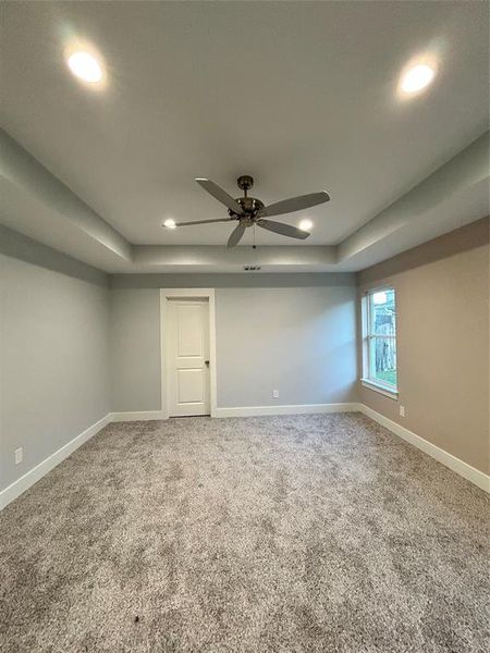 Carpeted spare room with ceiling fan