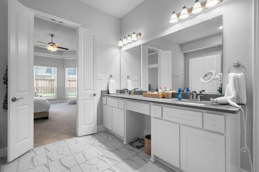 Primary Bathroom is well-lit and has double sinks