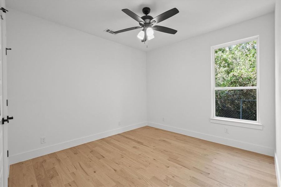 Spare room with ceiling fan and light wood-type flooring