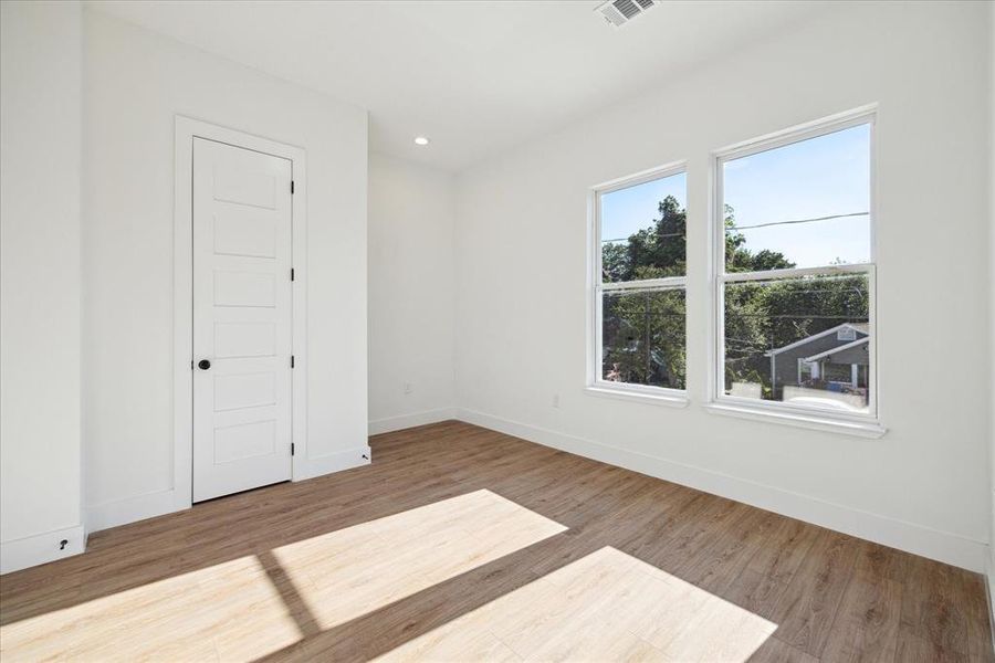 Third bedroom features recessed lighting and large windows.
