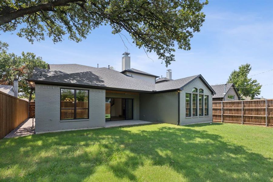 Back of house with a patio area and a yard