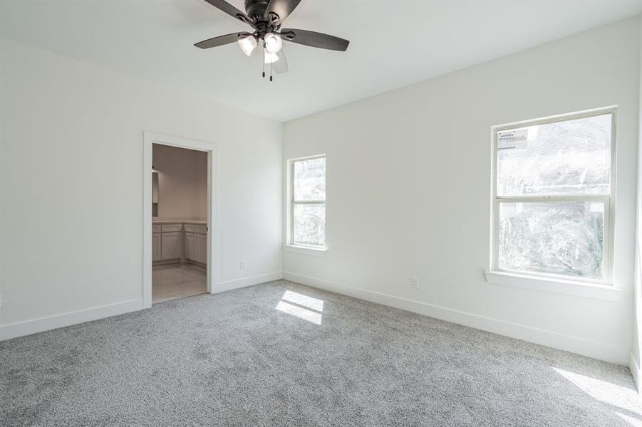 Unfurnished bedroom with carpet flooring, a closet, ceiling fan, and a spacious closet