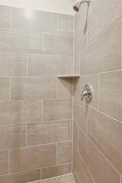 Room details featuring tiled shower