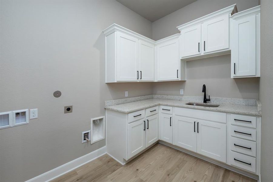 This perfect laundry room provides extra storage and a sink.