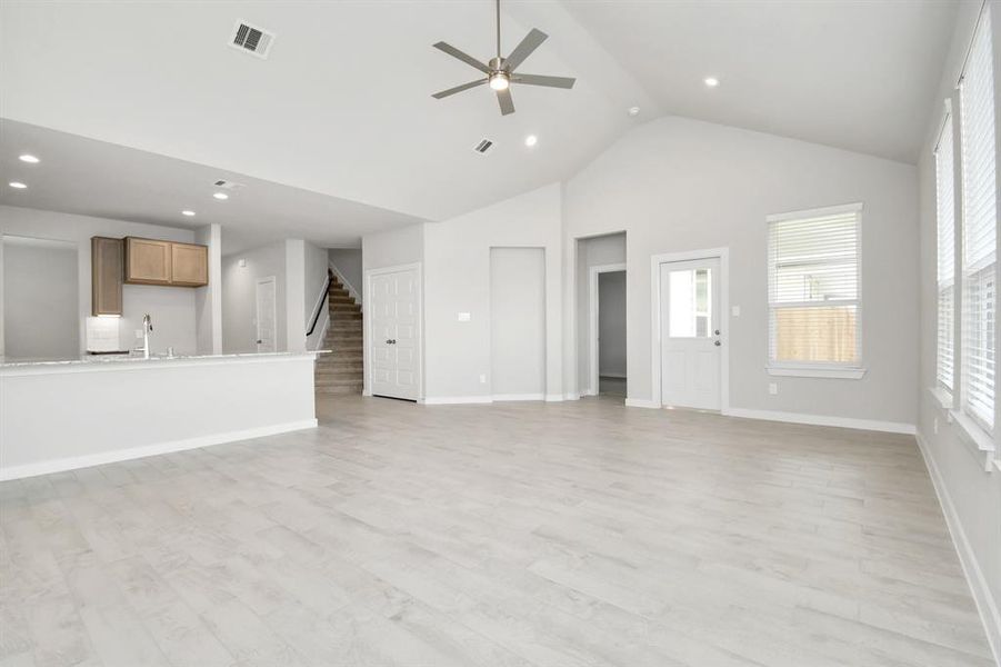 Discover another perspective of the open concept that unites the family room with the kitchen area! Sample photo of completed home with similar floor plan. Actual colors and selections may vary.