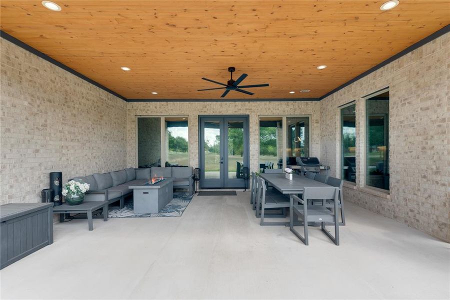 View of patio / terrace featuring an outdoor living space, ceiling fan, and french doors