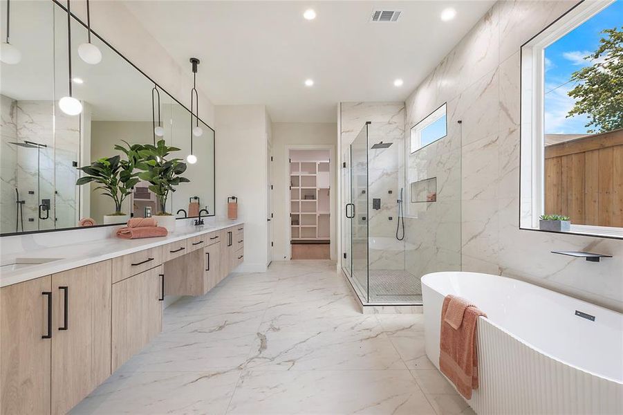 Bathroom with independent shower and bath, tile patterned floors, a wealth of natural light, and dual bowl vanity