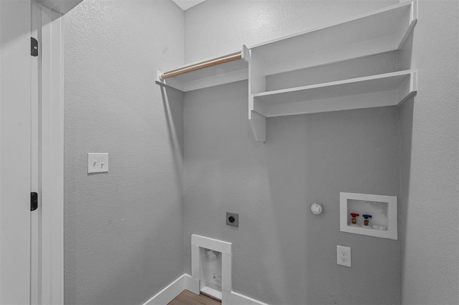 Laundry room featuring hookup for a washing machine, wood-type flooring, gas dryer hookup, and electric dryer hookup