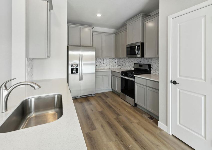 The stunning kitchen of the Chatfield comes with gorgeous wood cabinets and a beautiful backsplash.