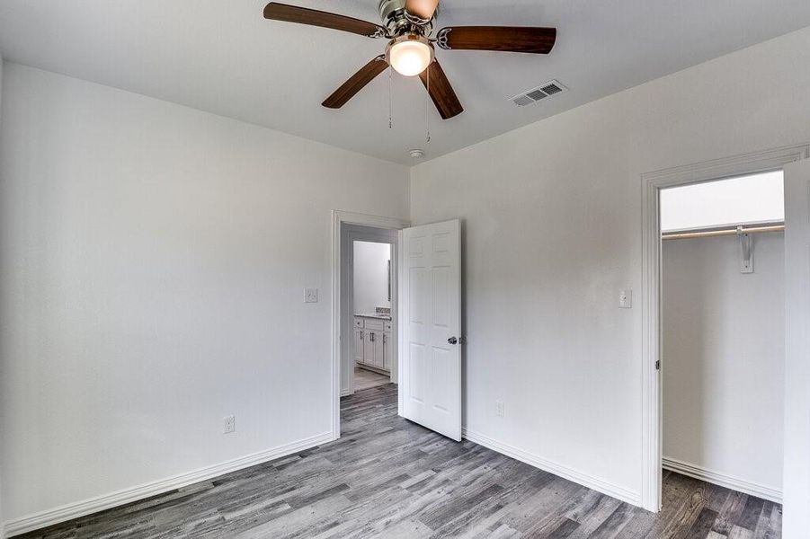 Unfurnished bedroom featuring light hardwood / wood-style flooring, a closet, and ceiling fan