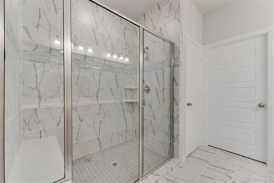 Bathroom with tile patterned floors and an enclosed shower