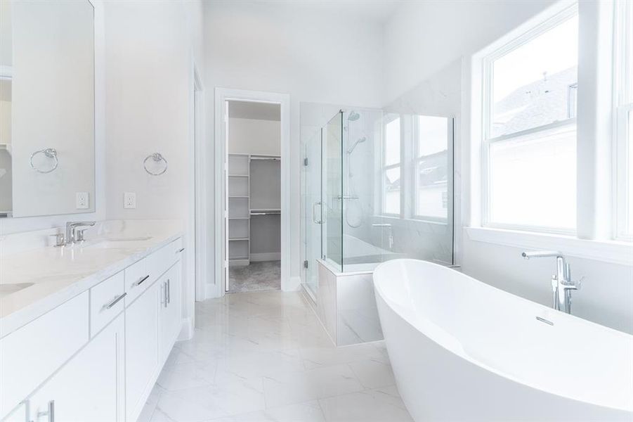 Primary bathroom with lovely tub and large shower.