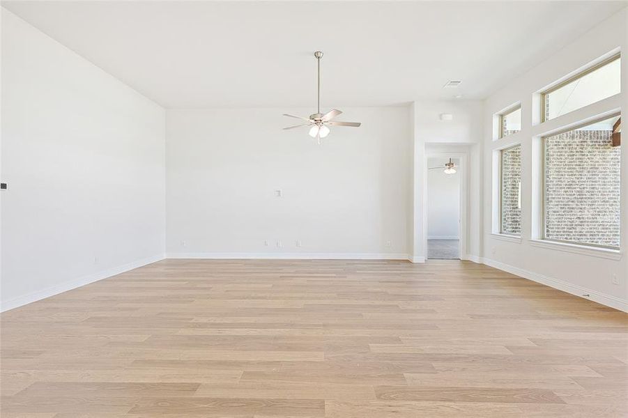 Unfurnished room featuring ceiling fan and light hardwood / wood-style floors