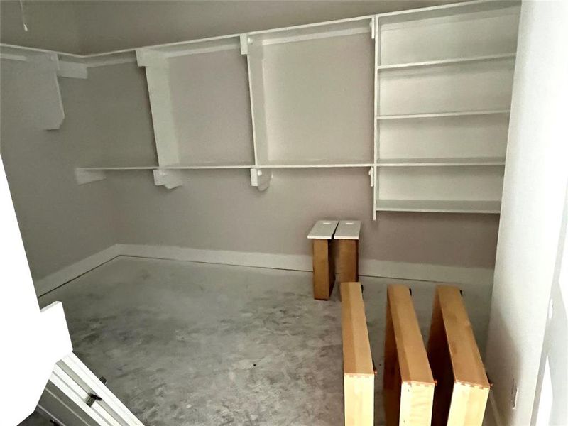 The larger of two primary closets. This one connects to the laundry room
