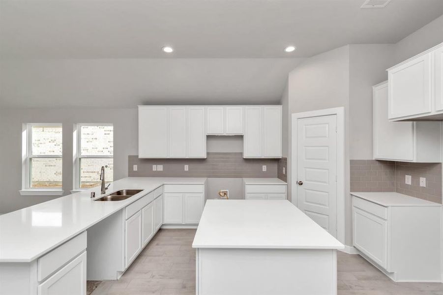 Another view of the spacious kitchen. Sample photo of completed home with similar floor plan. As-built interior colors and selections may vary.