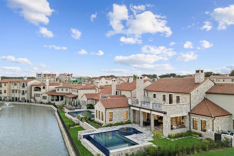 Dock area with a water view, a balcony, and a fenced in pool