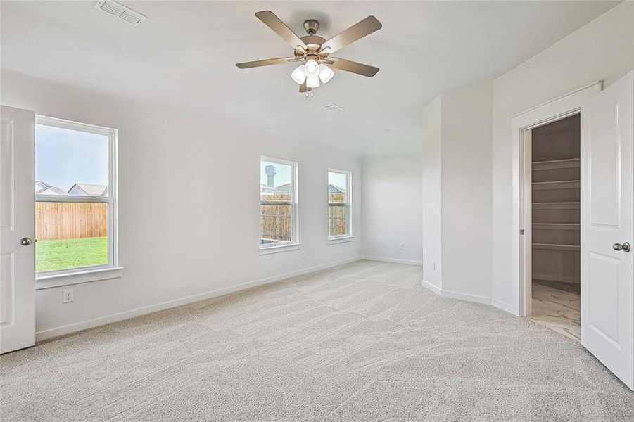 Spare room with light colored carpet and ceiling fan