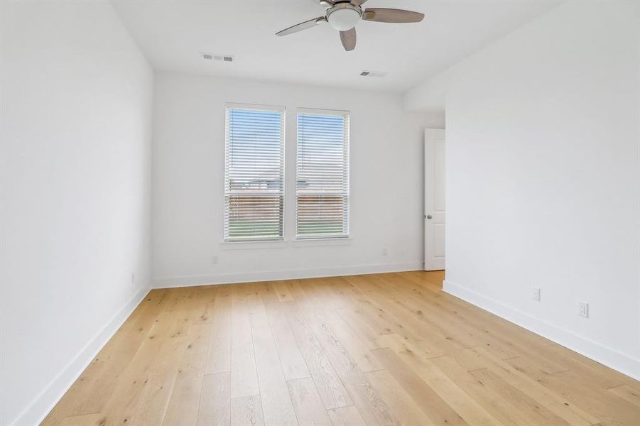 Main Bedroom with plenty of natural light, ceiling fan, and light hardwood / wood-style flooring