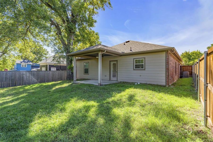 Back of property featuring a patio area and a yard