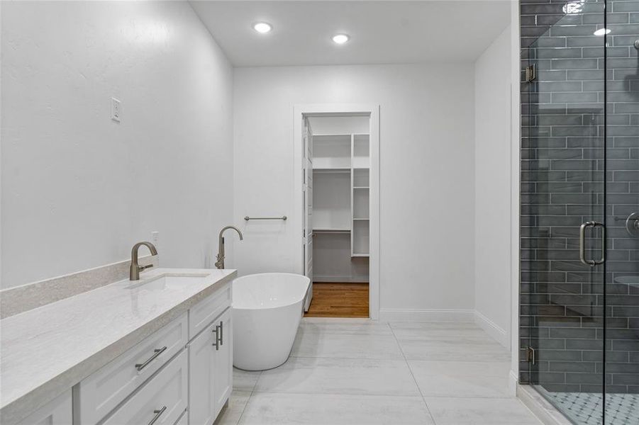 Bathroom with vanity and plus walk in shower