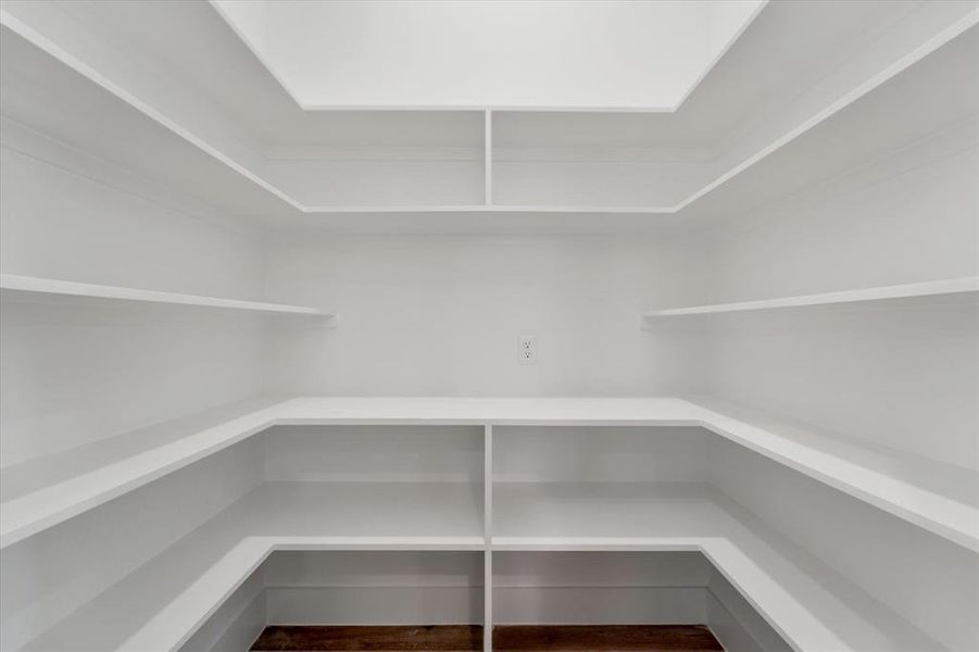 Find a spacious walk in pantry with plenty of shelving and even an outlet for your air fryer or coffee station.