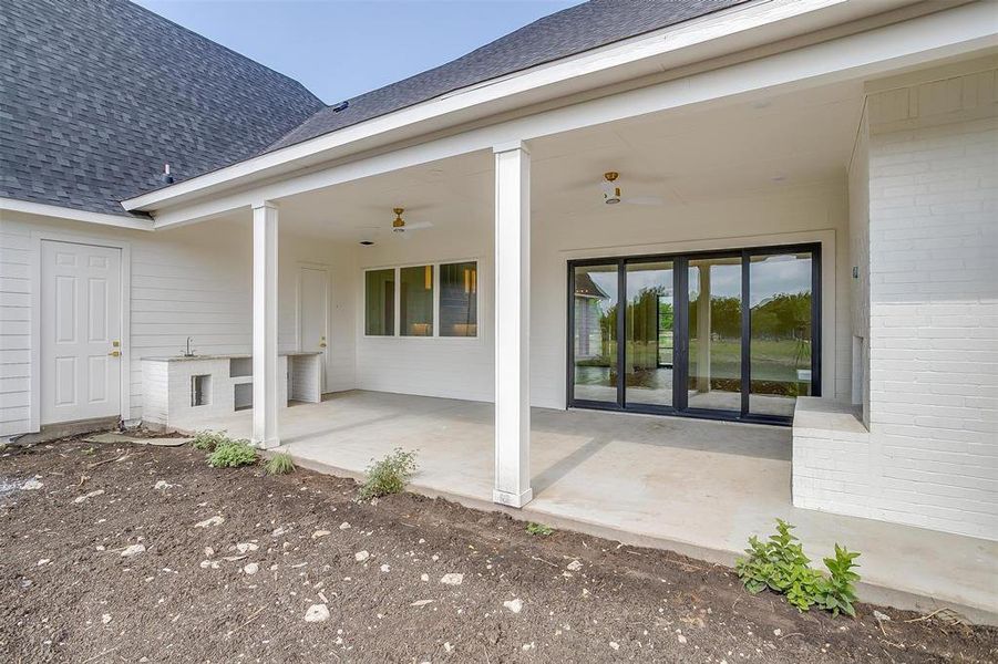 Back of property with a patio and ceiling fan