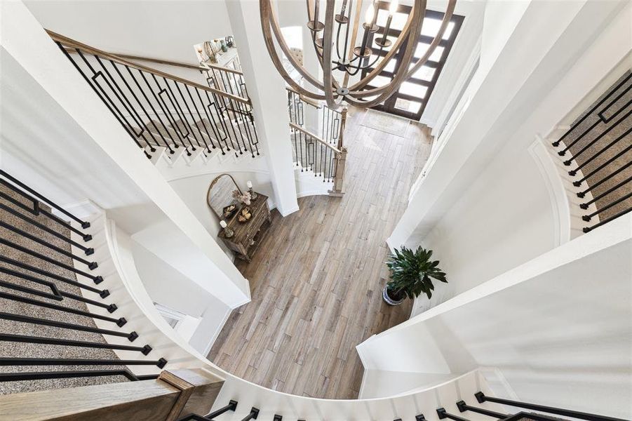 A view from the top of the curved staircase to the lower level.